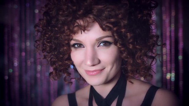 4k Disco Curly Sexy Woman Turns at Camera Smiling Happy