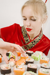 fun girl in the Japanese dress eats sushi