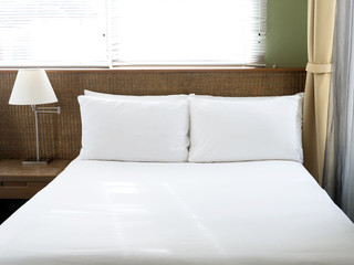 bedroom white pillow and white blanket natural light window