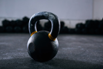 Naklejka na ściany i meble Close-up of kettlebell weight on gym floor