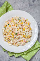 Salad with crab sticks, corn, cucumber, and eggs