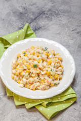 Salad with crab sticks, corn, cucumber, and eggs