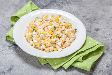 Salad with crab sticks, corn, cucumber, and eggs