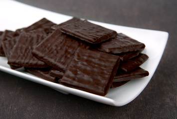 Dark Squares Chocolates. Chocolates in white plate.