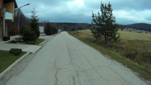 Cloudy autumn day. Car moves along a mountain road. Going astern car stops.