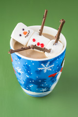 Mug with hot cocoa and marshmallow snowman.