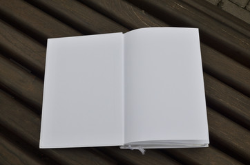 Opened book on a wooden surface with space for copy text as a background