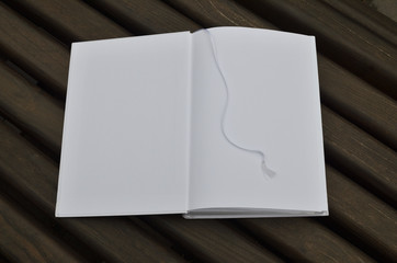 Opened book on a wooden surface as a background