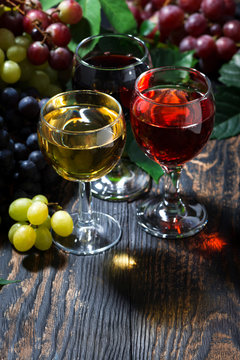 assortment of wine on wooden background, vertical