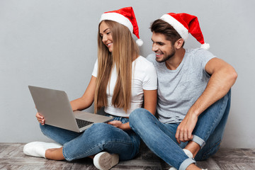 Portrait of christmas couple with laptop