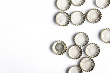 caps of beer on white background