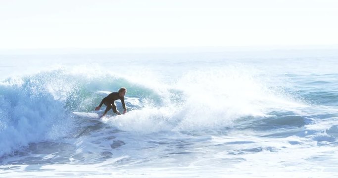 Surfers surfing in sea