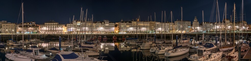 Panoramic night view of touristic sea sport harbor with modernist architecture buildings at down in...