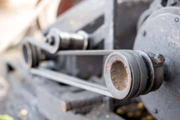 Close up engine transmission on belts and pulleys, old engine, dirty, full of oil contamination