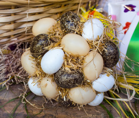 Easter eggs in the nest on rustic wooden background. /  Handmade eggs in festival Easter