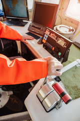 Man fishing vessel captain in the ship's wheelhouse. The control system, navigation system. Fishing, industry, fishery. © scharfsinn86