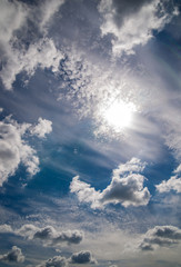 Fototapeta na wymiar bright blue sky with clouds and sun 