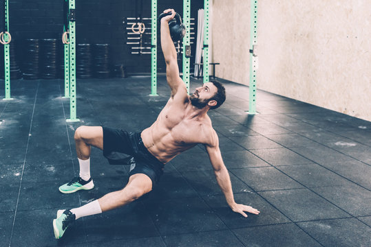 Young man training with kettle bell