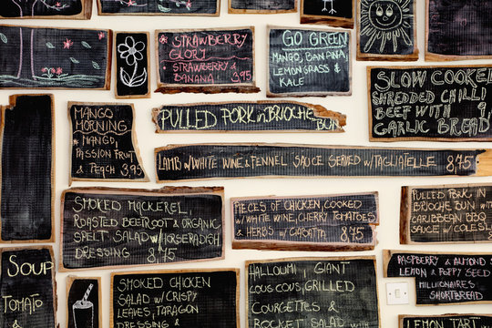 Quirky coffee shop interior with menu on chalked blackboards