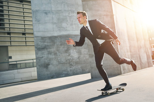 Extremal man wearing suits rides a skateboard Stock Photo | Adobe Stock