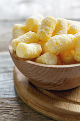 Corn sticks in a wooden bowl.