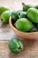Tropical fruit feijoa in a wooden bowl.
