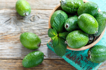 Ripe feijoa in a wooden bowl.