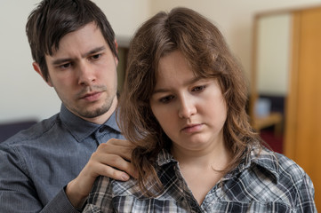 Young man is supporting his worried girlfriend.