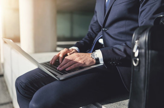 Sitting Businessman Working With A Gray Laptop