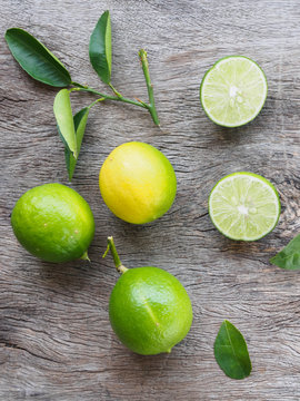 top view  fresh green lemon fruit and lemon cutting on wooden ba