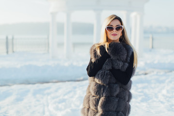 Portrait of a glamorous business woman in the winter street.