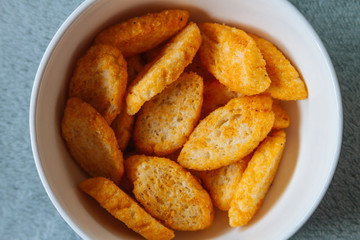 Toast with olive oil in a white bowl viewed from above on plush