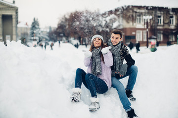 Happy stylish couple in winter city.