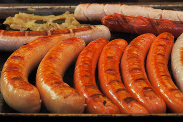 Sausages with brown grill marks in a grill pan.German sausages with cabbage