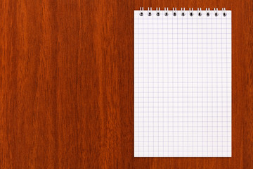 Blank notebook on a wooden background, copy space, top view