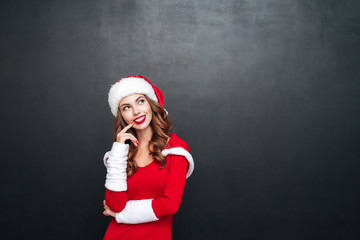 Beautiful wondered woman in red dress and hat looking away