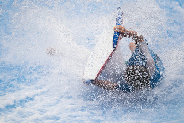 Naklejka premium Man falling from a surfing board on FlowRider.