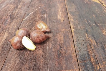 Salak, Sala, Palm Closeup, Asian fruit (Salacca zalacca) on wooden floor  background