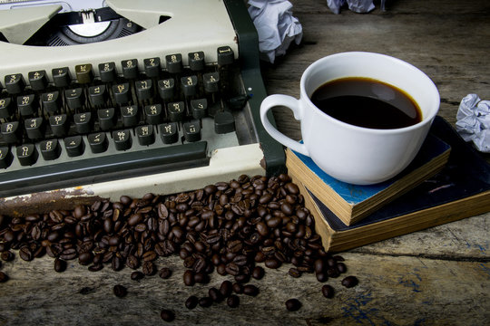 typewriter and coffee on wood background