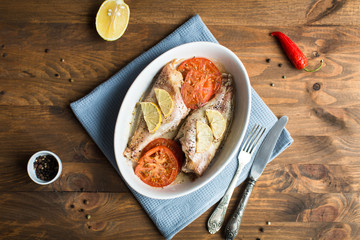 Baked sea bass with tomatoes and lemon
