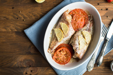Baked sea bass with tomatoes and lemon