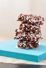 chocolate crisps from puffed rice on the blue stand on a light background