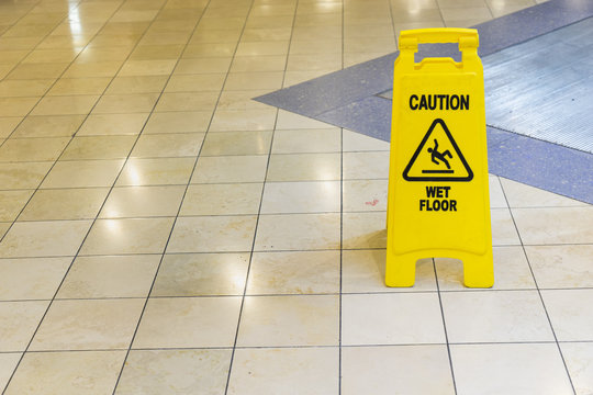 yellow wet sign on the floor - can use to display or montage on product