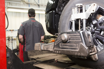 Mechanic working on car in his shop