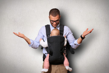 Father holds a baby in a bag