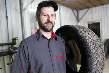 Mechanic working on car in his shop