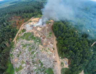 The fire brigade puts out the fire at the solid waste landfill. The view from the height of smoke...