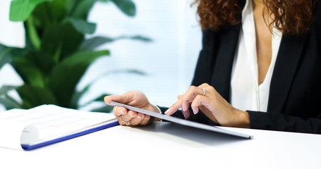 Woman using a tablet in her office.