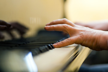 Male hand playing the piano