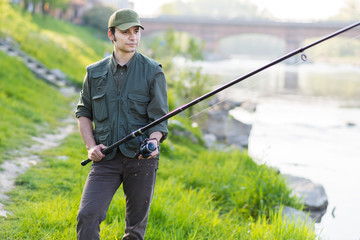 Young fisherman at the river